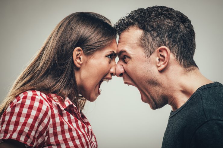 Man and woman head-to-head shouting