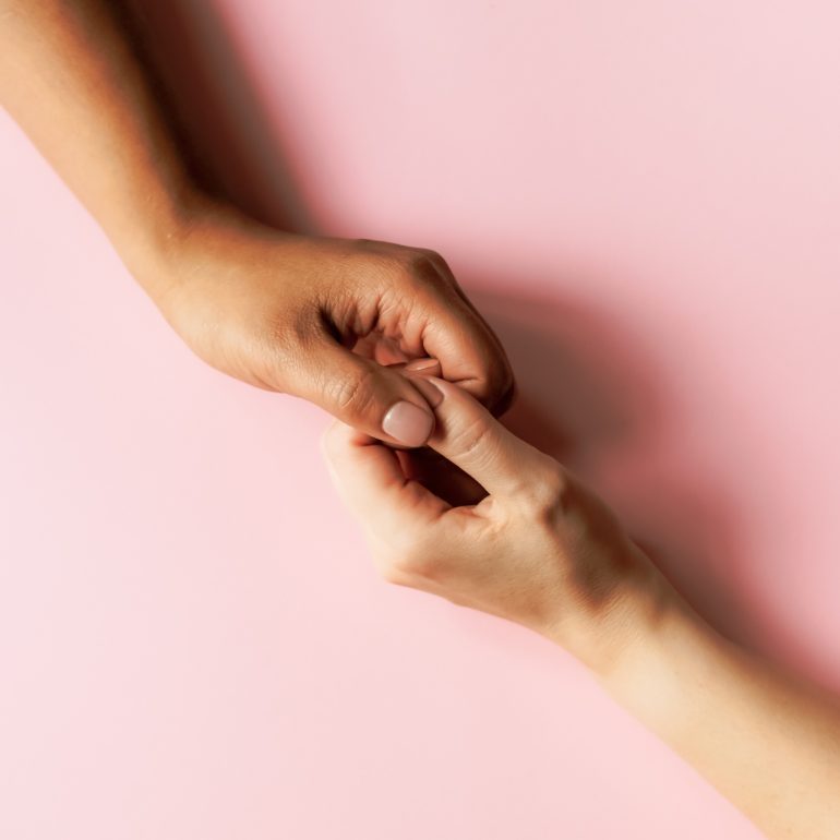 Two hands reaching out to touch