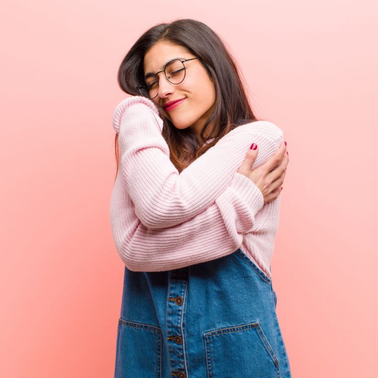 Girl hugging herself self care