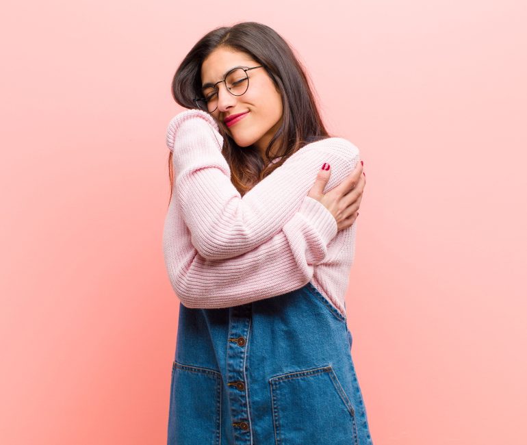 Girl hugging herself practising self care